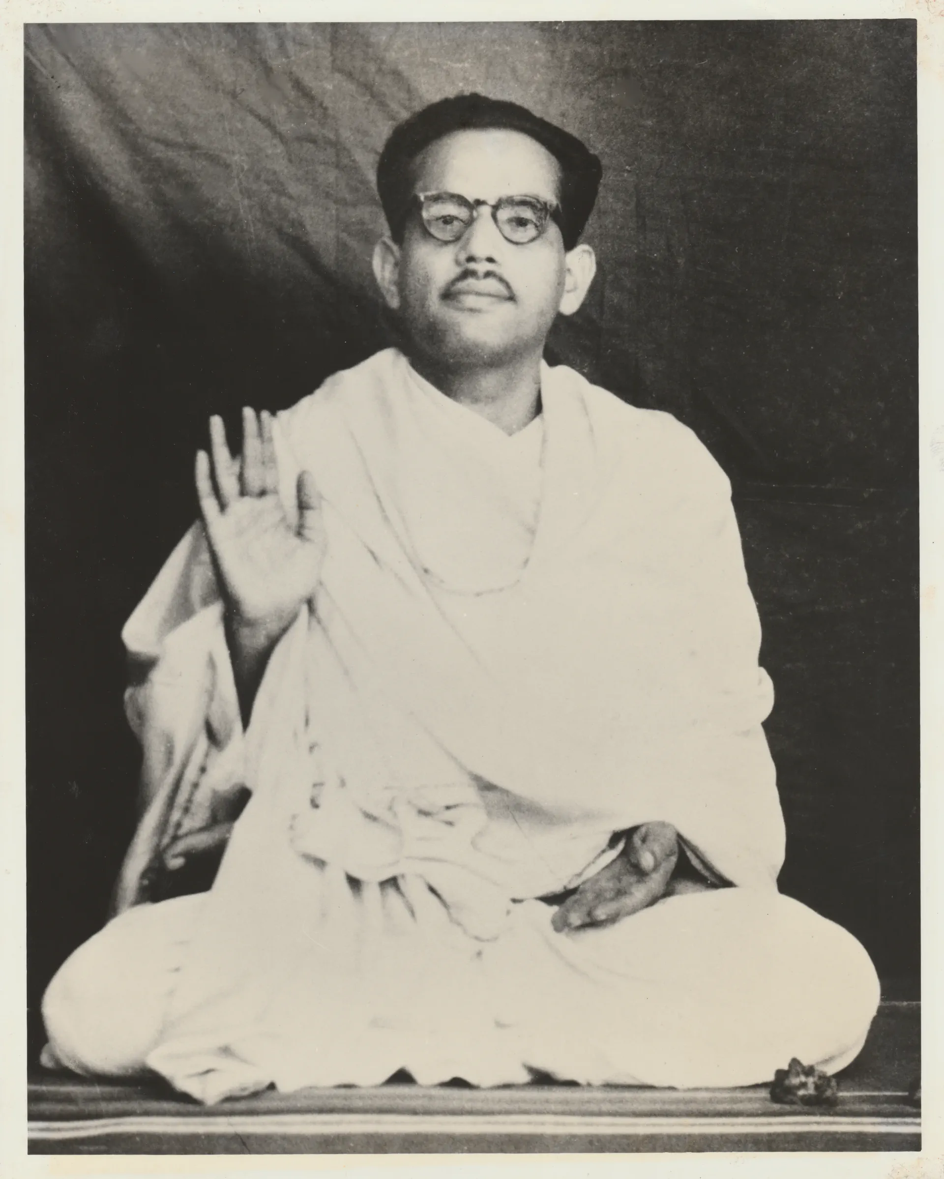 Shrii Shrii Anandamurti seated, hand raised in varabhaya mudra