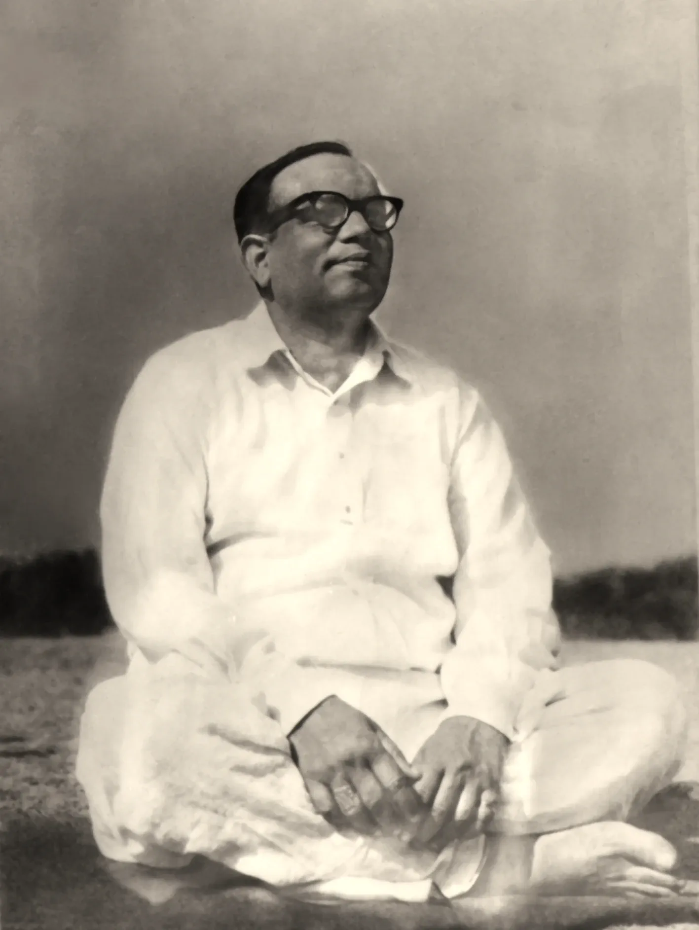 Shrii Shrii Anandamurti seated in an open field