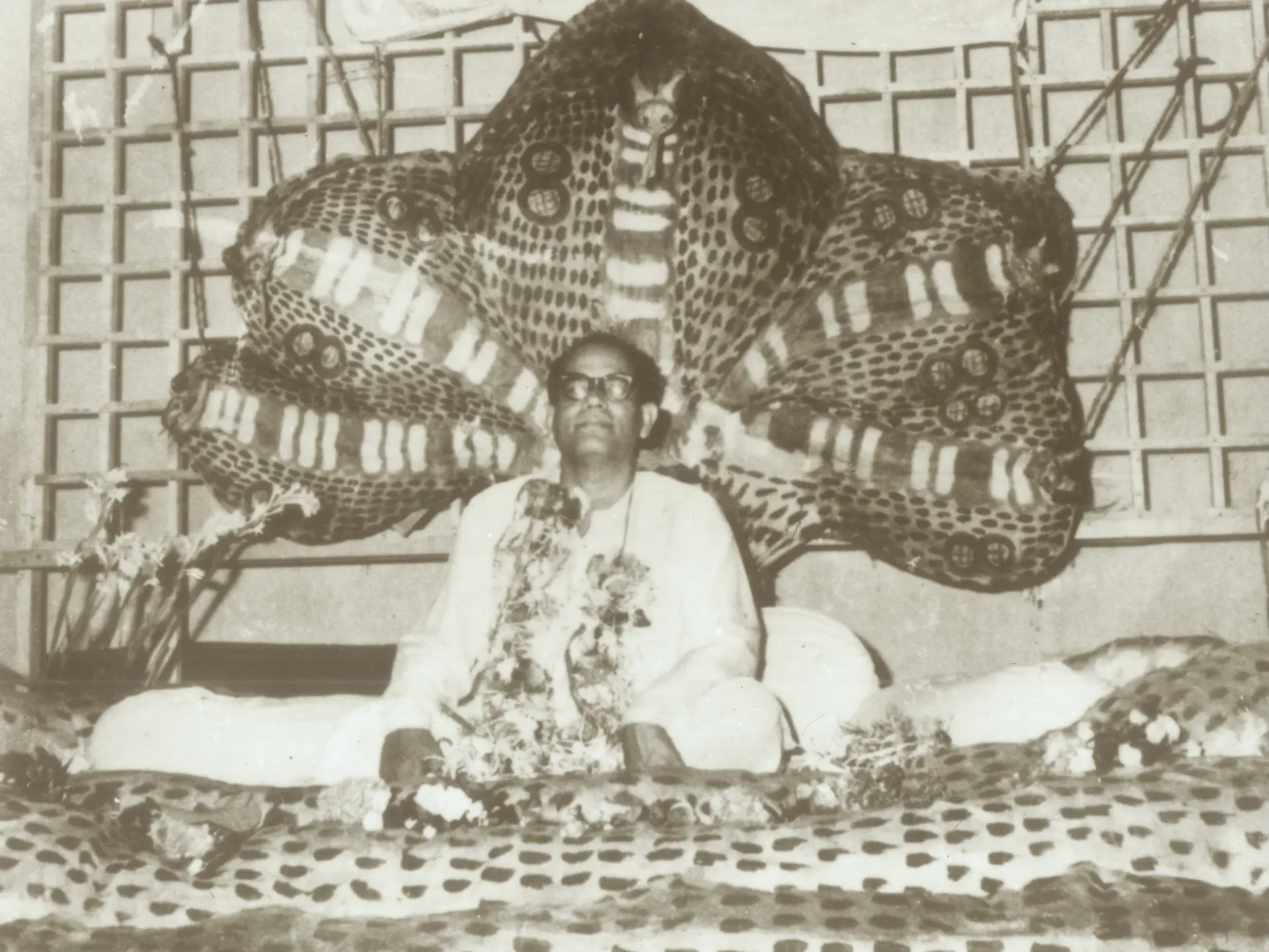 Shrii Shrii Anandamurti seated at a decorated gathering