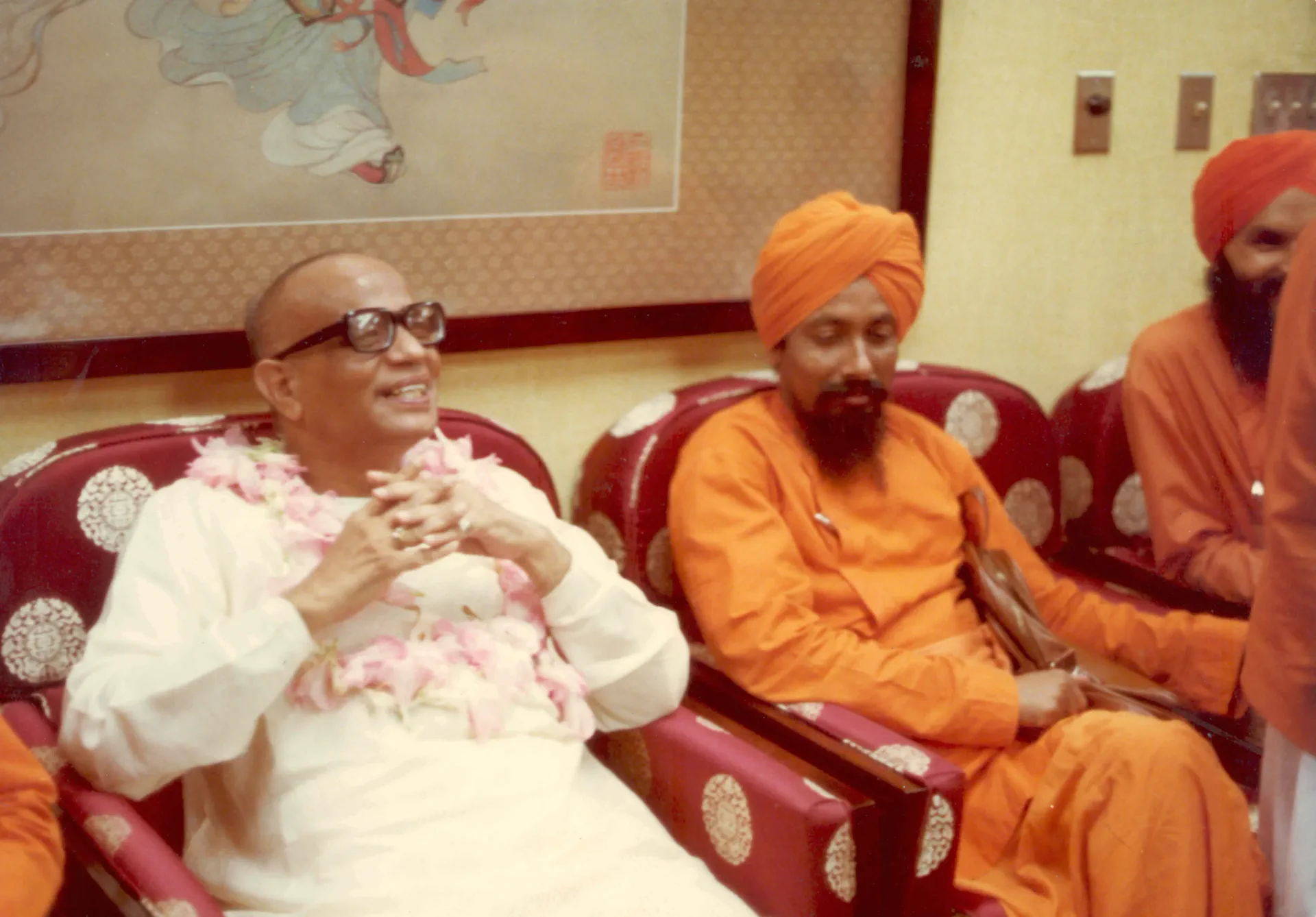 Shrii Shrii Anandamurti seated in conversation with an acarya